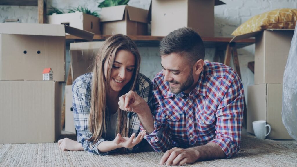 Happy young couple with house keys moving into their first home in Montgomery County TX